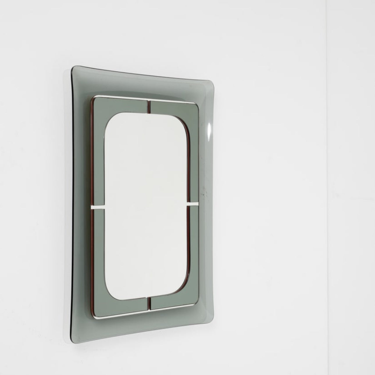 Metallic rectangular mirror on a wall