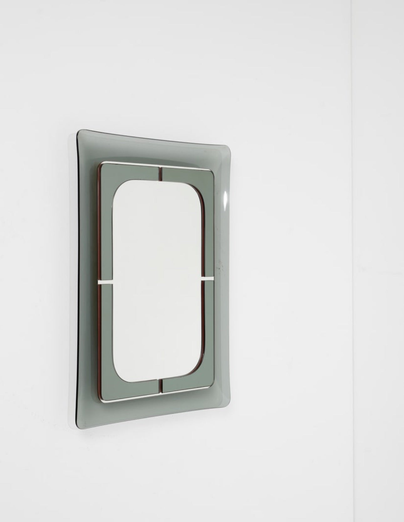 Metallic rectangular mirror on a wall